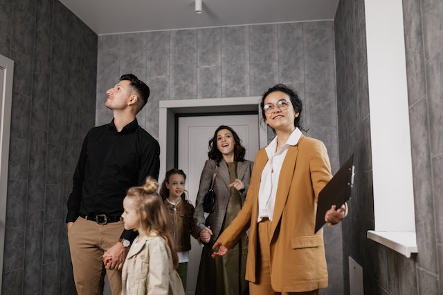 A real estate agent showing a home to a family.