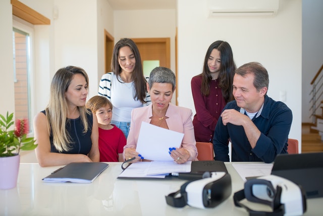 A family talking to a real estate agent.
