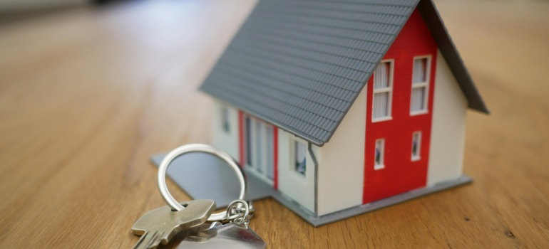 A house miniature with a key.